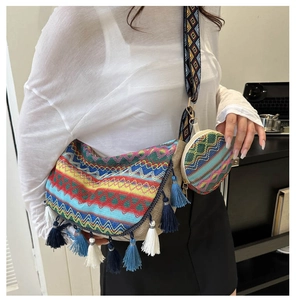 Detail of bohemian woven tote bag with fringe tassels and colorful ethnic shoulder strap