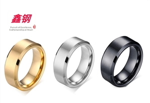Close-up of brushed stainless steel rings in gold, silver, and matte black finishes