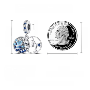 Size detail of S925 silver mermaid charm with colorful zircon next to a quarter coin