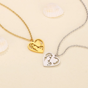 Detailed close-up of heart-shaped mother and child silhouette necklaces in gold and silver