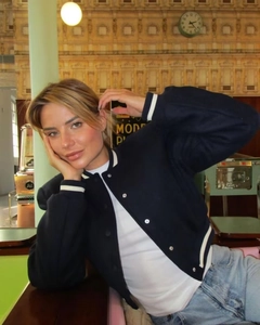 Detail of navy blue color-block baseball jacket with metal buttons and stand collar