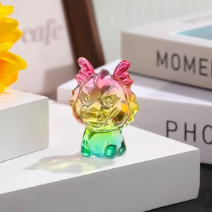 Detail of colorful dragon zodiac ornament in pink and yellow gradient crystal glass