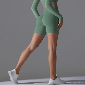 Detail view of high waist scrunch butt yoga shorts and crop top in sage green sport set