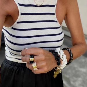 Detailed look at chic black and white enamel jewelry set with Love pendant necklace