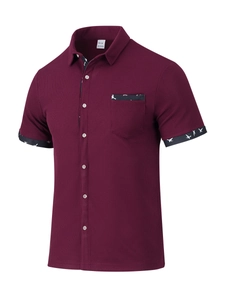 Detail of burgundy waffle knit texture and printed cuff stitching on men's short sleeve shirt