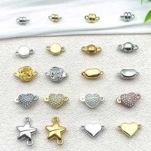 Macro detail of various magnetic jewelry clasps in heart, star, and round shapes on beige fabric