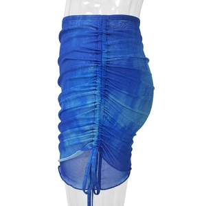 Detail of blue tie-dye mesh mini skirt featuring side drawstring and ruched texture