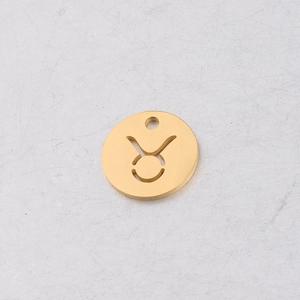 Macro view of gold stainless steel Taurus zodiac pendant with cutout geometric detail