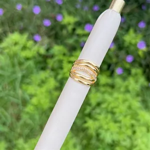 Macro shot of 18K gold plated multi-layer intertwined ring with shimmering zircon stones