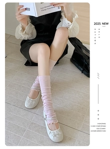 Detail of pink knitted leg warmers styled with pearl Mary Jane shoes for a sweet look
