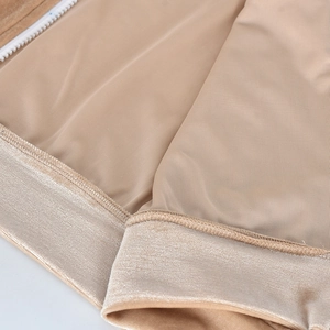 Detail of khaki velvet fabric with smooth lining and high-quality white zipper stitching