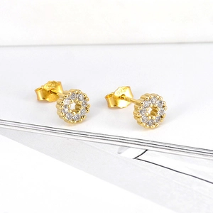 Macro view of gold hoop earrings with micro-pave cubic zirconia and s925 silver hallmarks