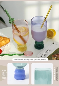 Detail of creative contrast color glass cup with colorful spiral straw and base