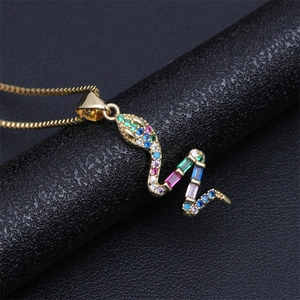 Macro shot of gold snake pendant necklace featuring vibrant multi-colored zircon stones