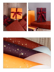 Macro view of gift wrapping paper rolls featuring premium gold foil texture and warm colors