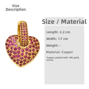 Detail view of heart-shaped earring with red zircon inlay and size dimensions 2.2cm x 1.7cm