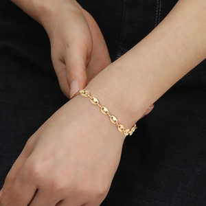 Fashionable gold coffee bean link bracelet for women shown on a model wrist