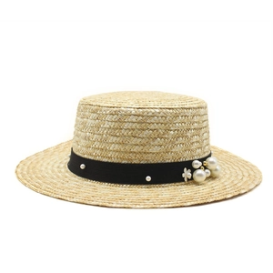 Flat top straw boater hat with wide brim, black ribbon, pearls and floral ornament