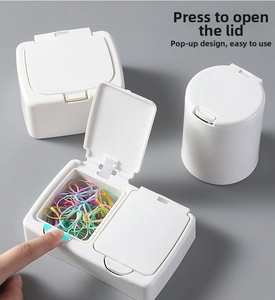 Close-up of minimalist white plastic desk organizer with a push-button pop-up lid