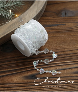 Macro detail of iridescent white heart bead garland for Christmas tree decoration