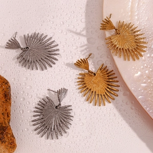 Artistic 18K gold and silver fan leaf earrings on a creative water drop textured background