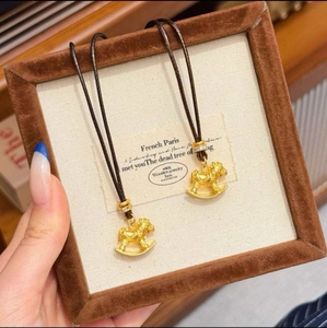 Elegant 24k gold plated horse pendant necklace with black cord in a velvet gift box