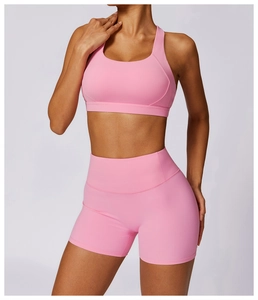 Close-up of pink high-waist fitness shorts and sports bra set with seamless texture