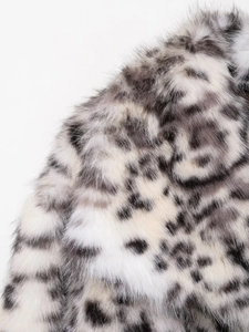 Detailed view of plush snow leopard print faux fur jacket showing soft collar texture