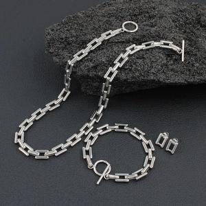 Polished stainless steel OT buckle jewelry set with rectangle links on black rock
