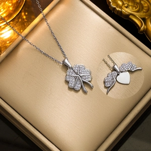 Silver four-leaf clover pendant necklace with cubic zirconia and foldable heart design