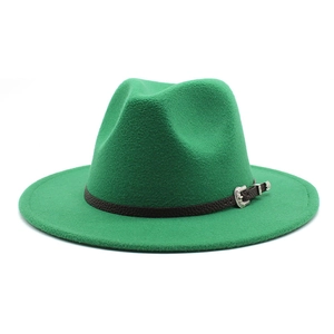 Detail of green wool jazz hat with black leather band and silver ethnic buckle decoration