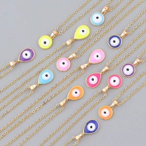 Detailed view of colorful enamel evil eye charms on golden waterdrop necklaces