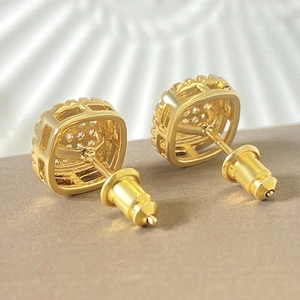 Macro side view of 18k gold plated square hip hop stud earrings with micro paved diamonds