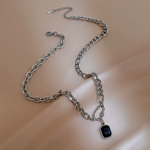 Minimalist silver chain necklace with octagonal dark purple glitter stone pendant on silk