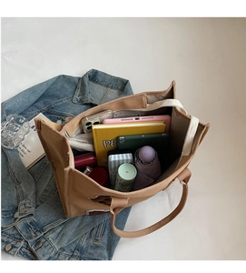 Top view of large khaki canvas tote bag showing interior space with tablet and essentials