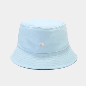 Detailed close-up of light blue cotton bucket hat with white polar bear embroidery