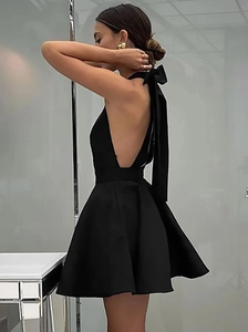 Elegant black halter backless mini dress with a large bow detail on the back