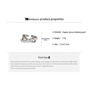 Detail view showing dimensions of a pearl and zircon cross ring made of plated copper