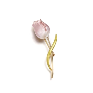 Detail view of tulip brooch featuring pink enamel petals and elegant golden stem