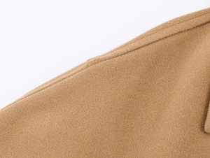 Close-up of premium camel wool blend fabric showing detailed texture of the coat