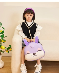Detail view of purple rabbit backpack held by a child in a cozy home setting