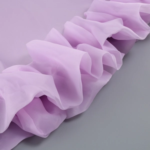 Detail of lavender pleated chiffon fabric with ruffled texture and elegant silk sheen