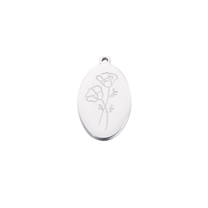 Macro shot of silver oval stainless steel pendant with engraved December birthday flowers