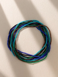 Macro shot of colorful Bohemian multi-layered beads chain with smooth textures