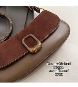 Detail of the vintage shoulder bag featuring mixed smooth leather and chocolate suede texture