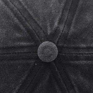 Detailed macro view of the vintage washed cotton baseball cap top with stitched seams