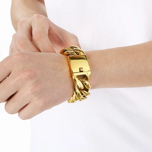 Detail of 25mm wide gold Cuban link bracelet showing the clasp and polished finish
