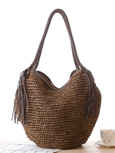 Brown woven paper rope tote bag with leather tassels and cylindrical handles for vacation