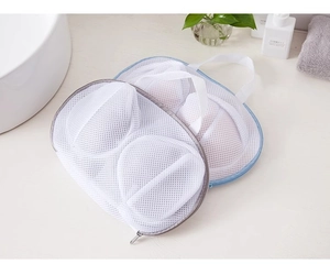 Detail of white polyester mesh laundry bag for bras with blue zipper and handle