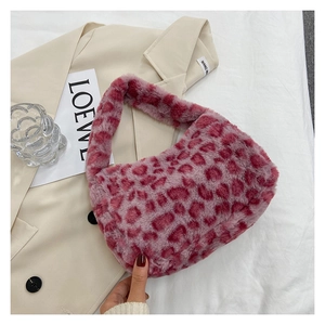Detailed view of the soft faux fur texture and pink leopard print on the handbag
